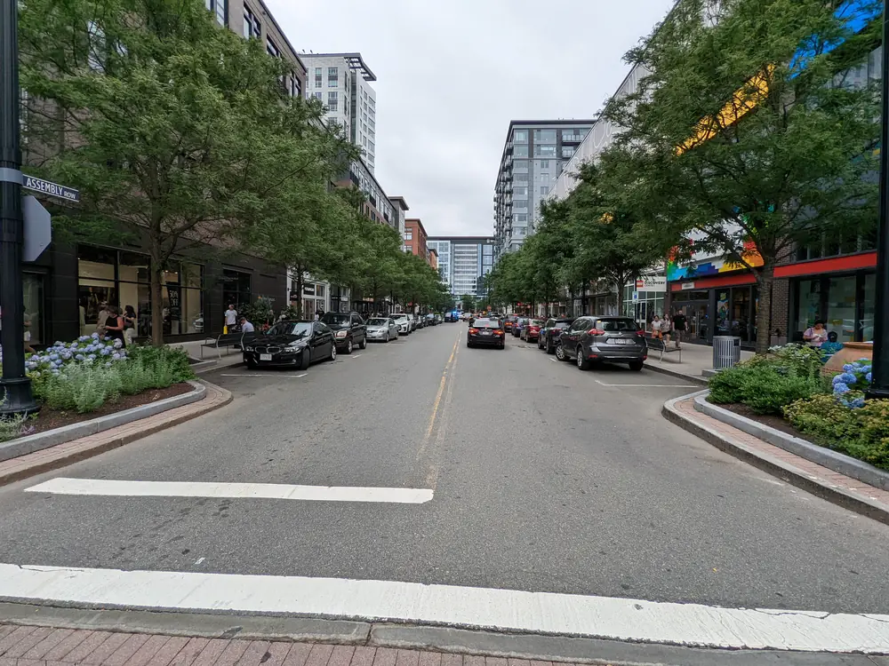Tree-lined street and mixed-use buildings along Assembly Row in Somerville